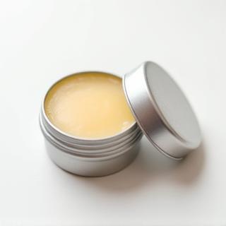 Handmade organic lip balm in a small metal pot